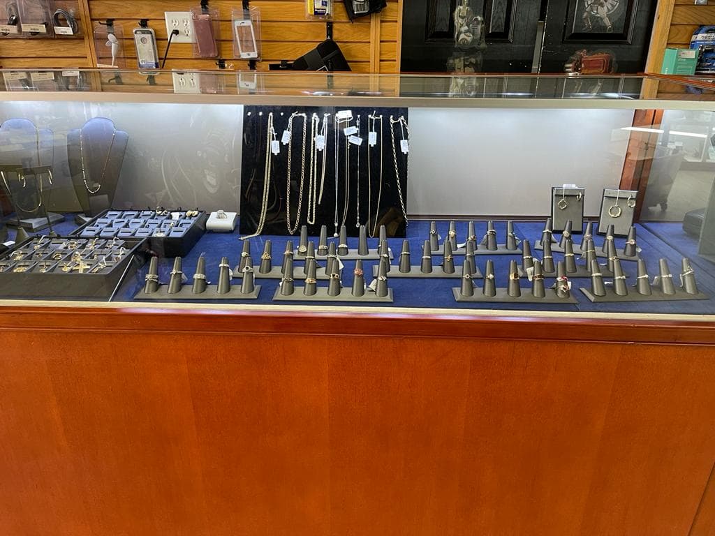 Gold jewelry being weighed and appraised at International Pawn Orlando